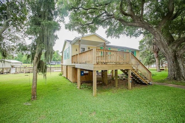 view of play area with a lawn, stairway, and a wooden deck