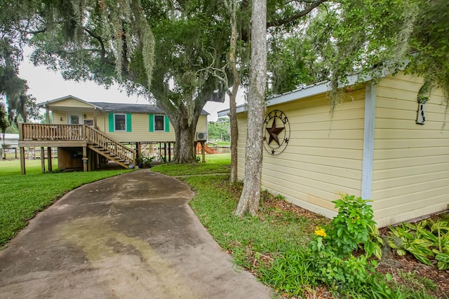 exterior space featuring a lawn and stairs