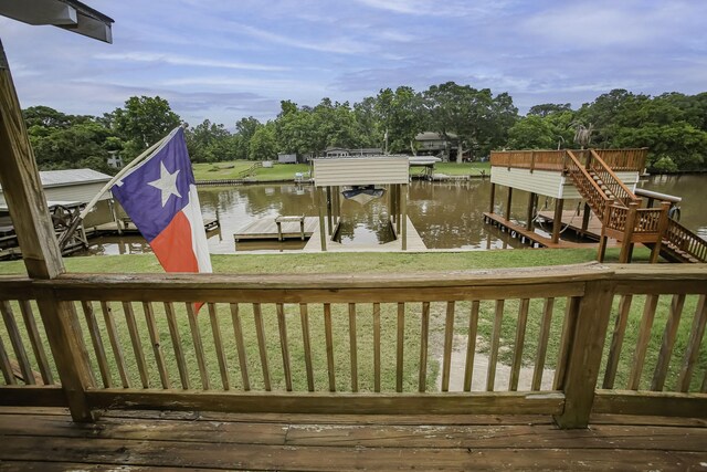 deck featuring a boat dock, a water view, and boat lift