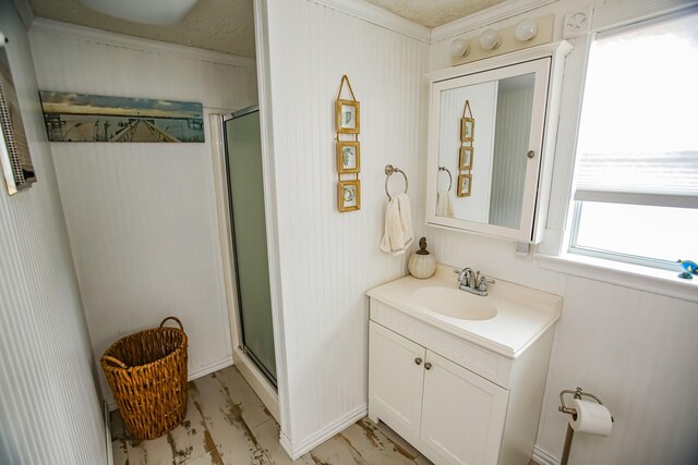 bathroom featuring a stall shower and vanity