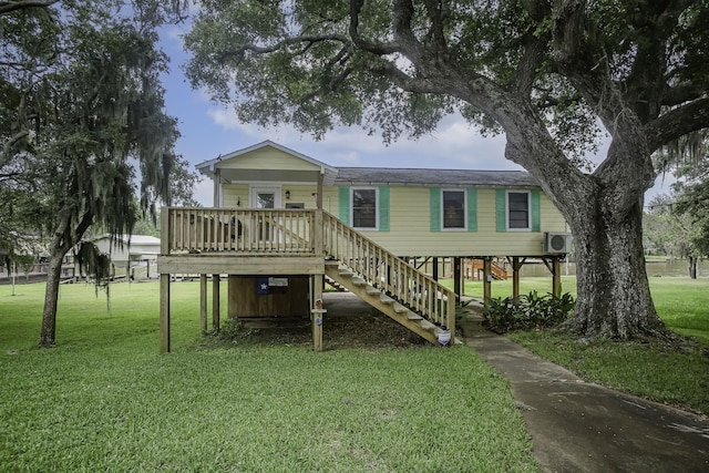 rear view of house with a carport, stairway, and a lawn