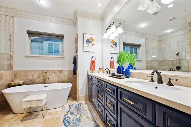 bathroom with tiled shower, a sink, visible vents, and tile walls