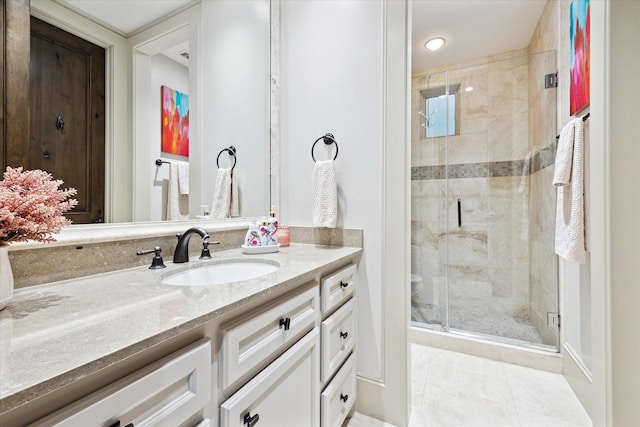 full bathroom featuring a stall shower, tile patterned flooring, and vanity