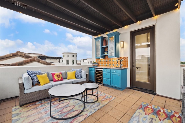 view of patio featuring beverage cooler, an outdoor hangout area, and a sink