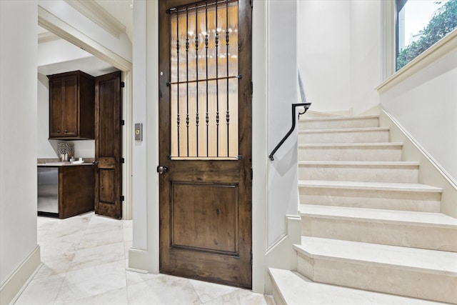 interior space featuring marble finish floor and baseboards