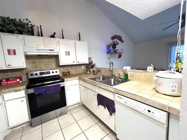 kitchen with lofted ceiling, white dishwasher, under cabinet range hood, a sink, and stainless steel electric range