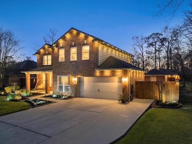 view of front of home with a front yard, brick siding, driveway, and an attached garage