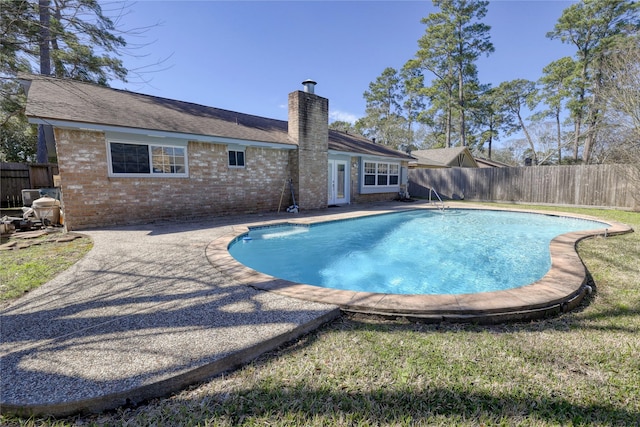 view of pool featuring a fenced in pool, a fenced backyard, and a lawn