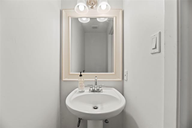 bathroom with visible vents and a sink