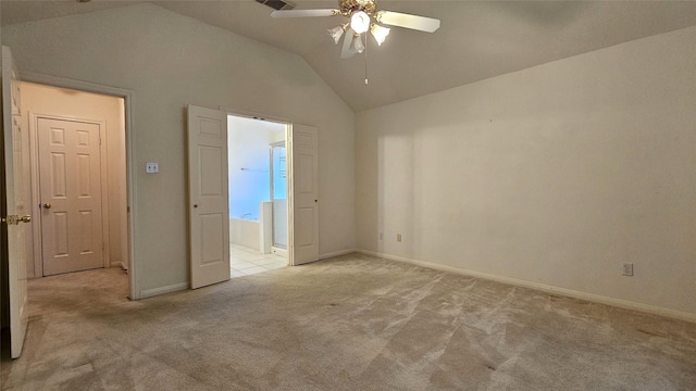 unfurnished bedroom with baseboards, ceiling fan, ensuite bathroom, vaulted ceiling, and carpet floors