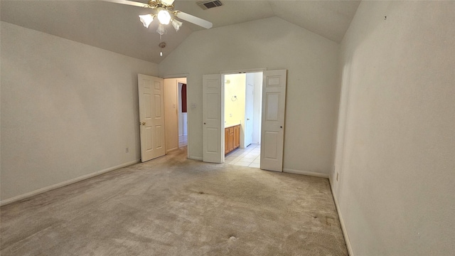 unfurnished bedroom featuring light colored carpet, visible vents, ensuite bathroom, high vaulted ceiling, and baseboards