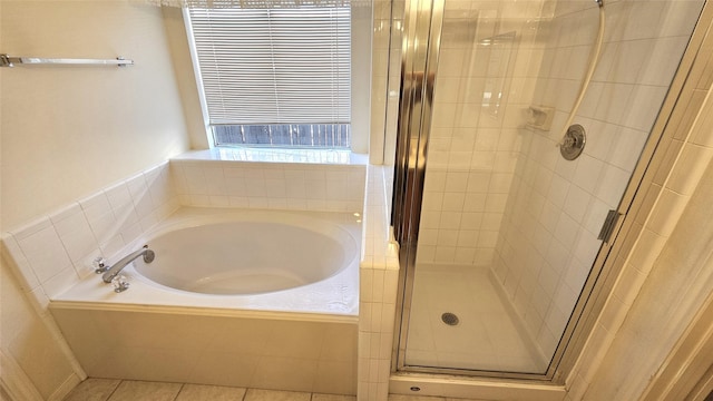 bathroom with a stall shower, a garden tub, and tile patterned floors