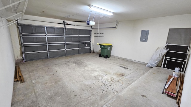 garage with a garage door opener and electric panel