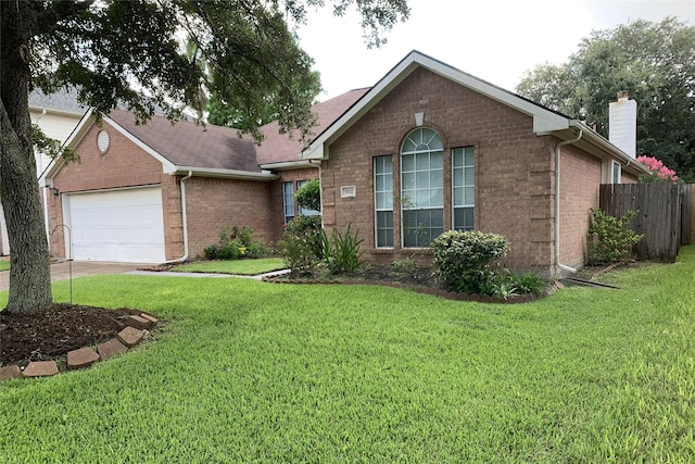 ranch-style house with brick siding, an attached garage, a front yard, fence, and driveway