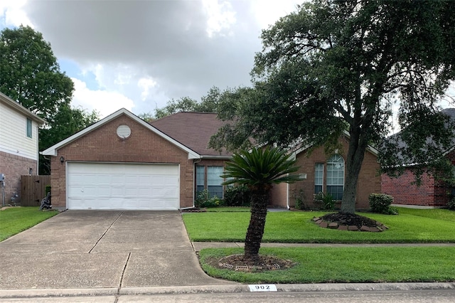 ranch-style house featuring a garage, driveway, a front lawn, and brick siding