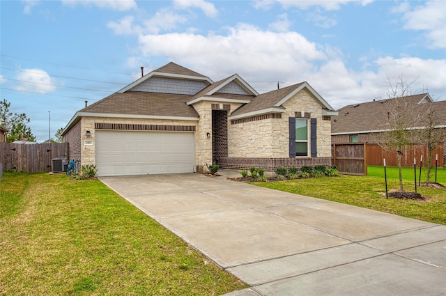 ranch-style house featuring fence, driveway, roof with shingles, an attached garage, and a front lawn