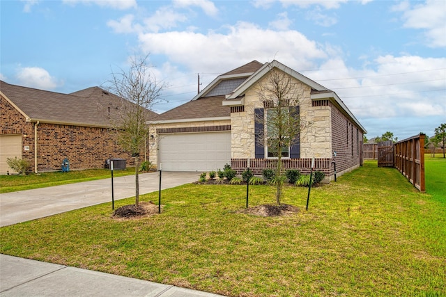 view of front of home featuring a front yard, an attached garage, stone siding, and driveway