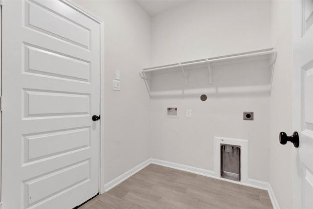 laundry area featuring hookup for a washing machine, baseboards, laundry area, electric dryer hookup, and light wood-type flooring