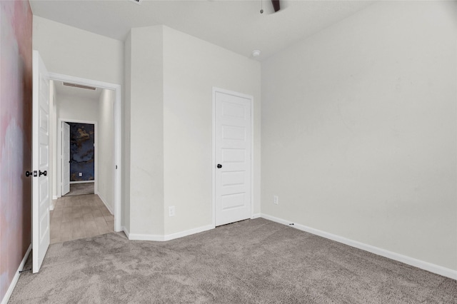 unfurnished bedroom with baseboards, carpet floors, and visible vents