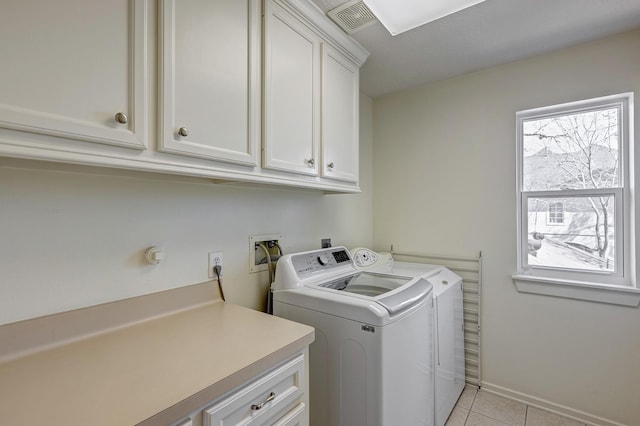 clothes washing area with cabinet space, independent washer and dryer, visible vents, and light tile patterned flooring