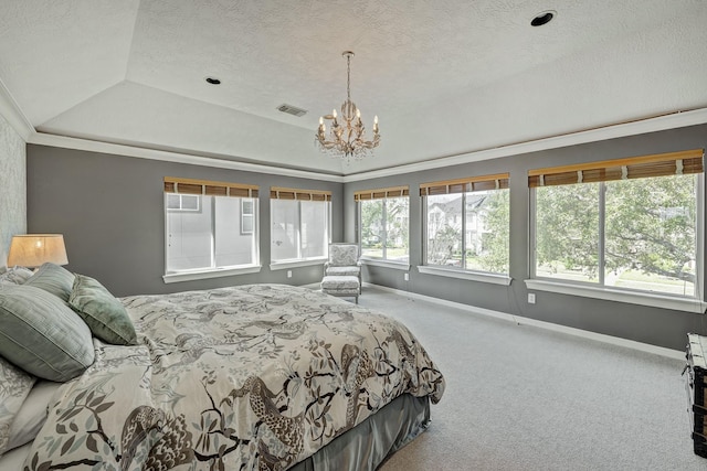 bedroom featuring a textured ceiling, carpet flooring, visible vents, baseboards, and a raised ceiling