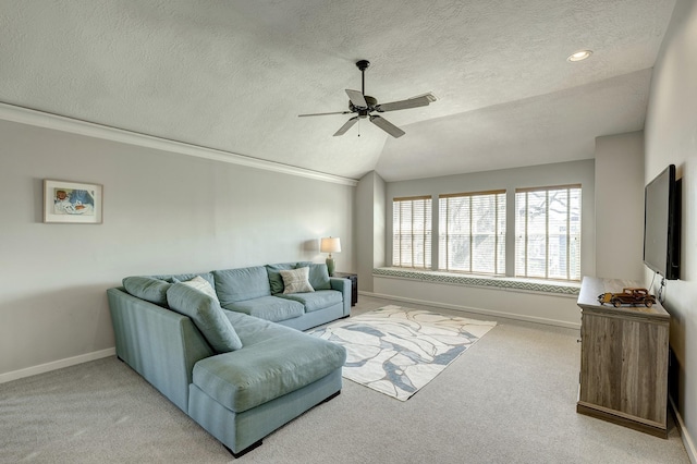 carpeted living room featuring vaulted ceiling, ceiling fan, a textured ceiling, and baseboards