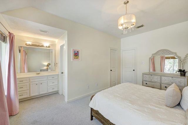 bedroom featuring baseboards, ensuite bath, visible vents, and light colored carpet