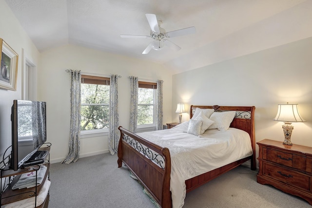 bedroom with light carpet, lofted ceiling, a ceiling fan, and baseboards