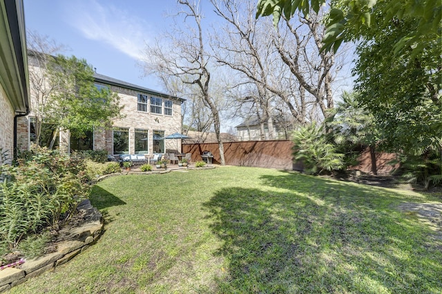 view of yard featuring a patio area and fence