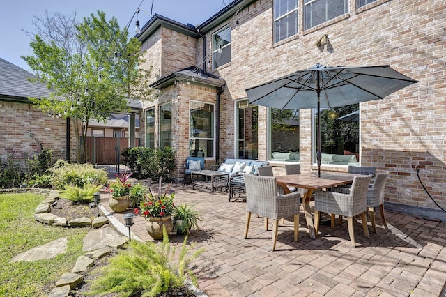 view of patio with fence, an outdoor hangout area, and outdoor dining space