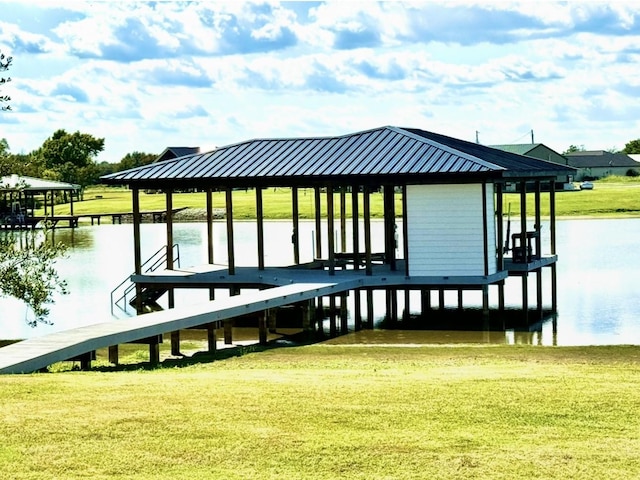 view of dock with a water view and a lawn