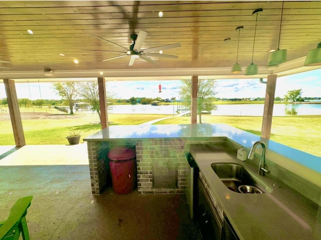 view of patio / terrace with a water view, a sink, and ceiling fan