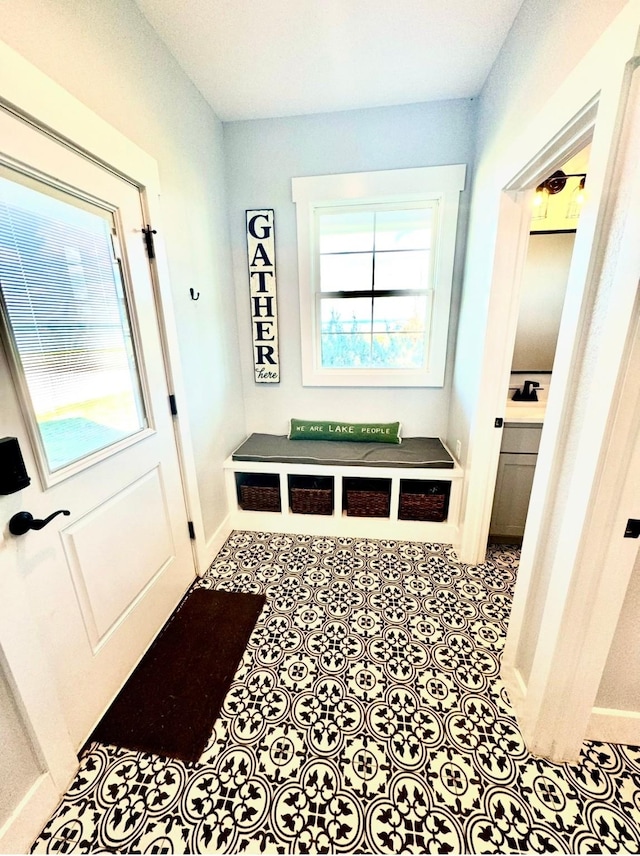 mudroom with tile patterned flooring and baseboards