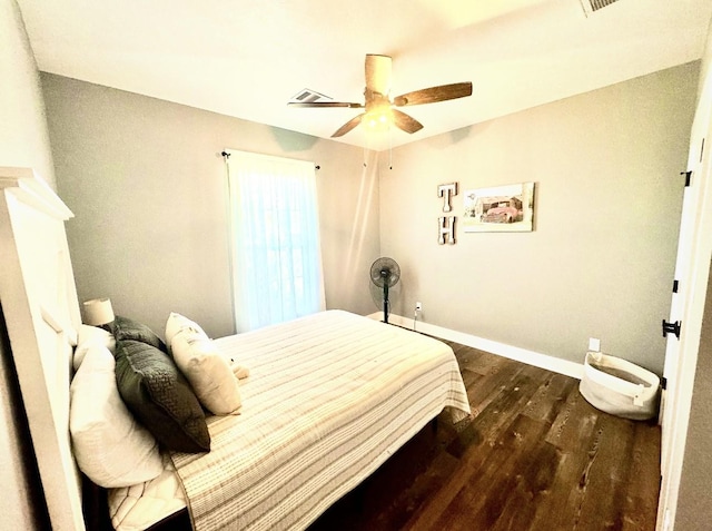 bedroom with dark wood-style floors, baseboards, and a ceiling fan