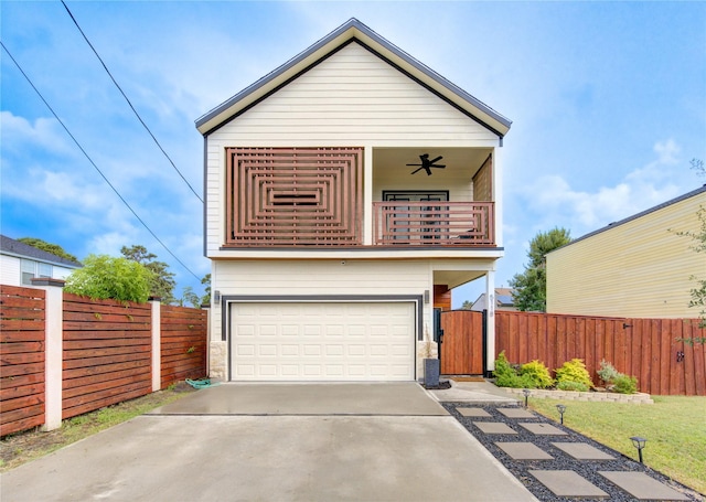 view of front of property with a balcony, a gate, fence, driveway, and ceiling fan