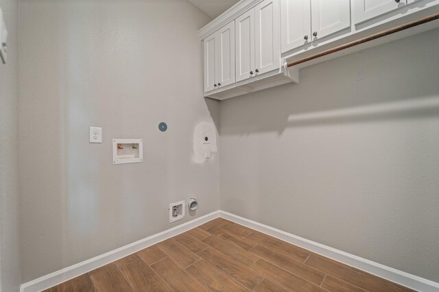 laundry room featuring washer hookup, cabinet space, dark wood-type flooring, electric dryer hookup, and baseboards