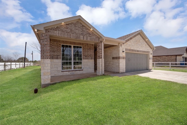 view of front of house featuring driveway, brick siding, an attached garage, fence, and a front yard