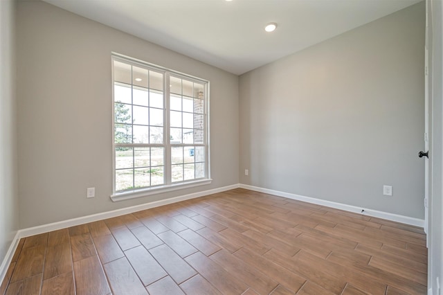 empty room with baseboards and wood finished floors