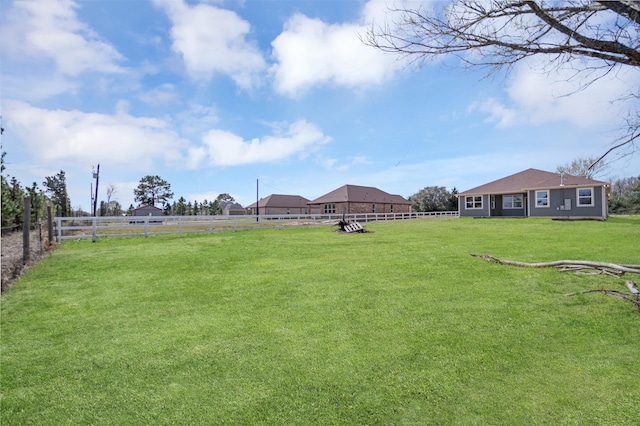 view of yard featuring a rural view and fence