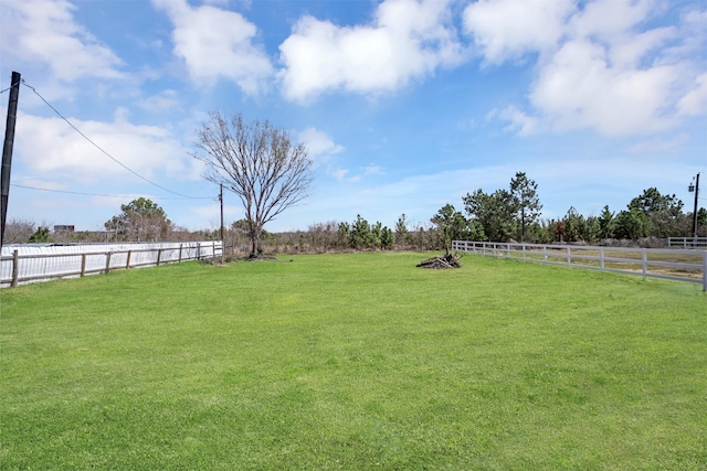 view of yard featuring fence and a rural view