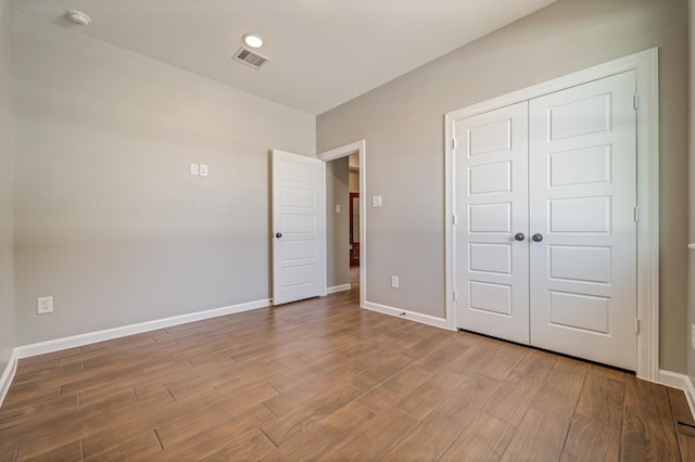 248 Alleda, Prairie View, TX 77484 - unfurnished bedroom with wood finished floors and a closet