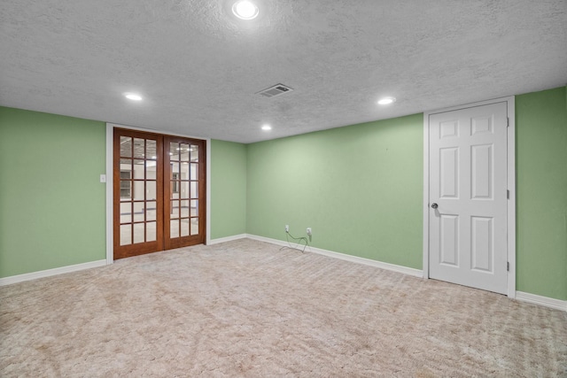 unfurnished room with french doors, visible vents, baseboards, and carpet flooring