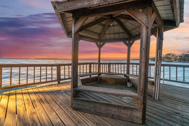 dock area featuring a water view and a view of the beach