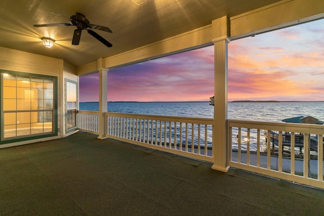 exterior space featuring a ceiling fan and a water view