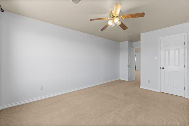 unfurnished bedroom featuring visible vents, attic access, a ceiling fan, light carpet, and baseboards