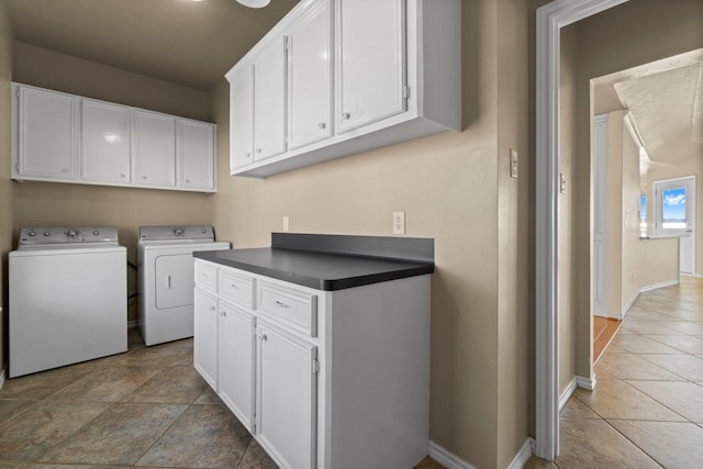 laundry room featuring cabinet space, washer and clothes dryer, and baseboards