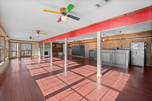 wooden terrace featuring exterior kitchen, visible vents, and a ceiling fan