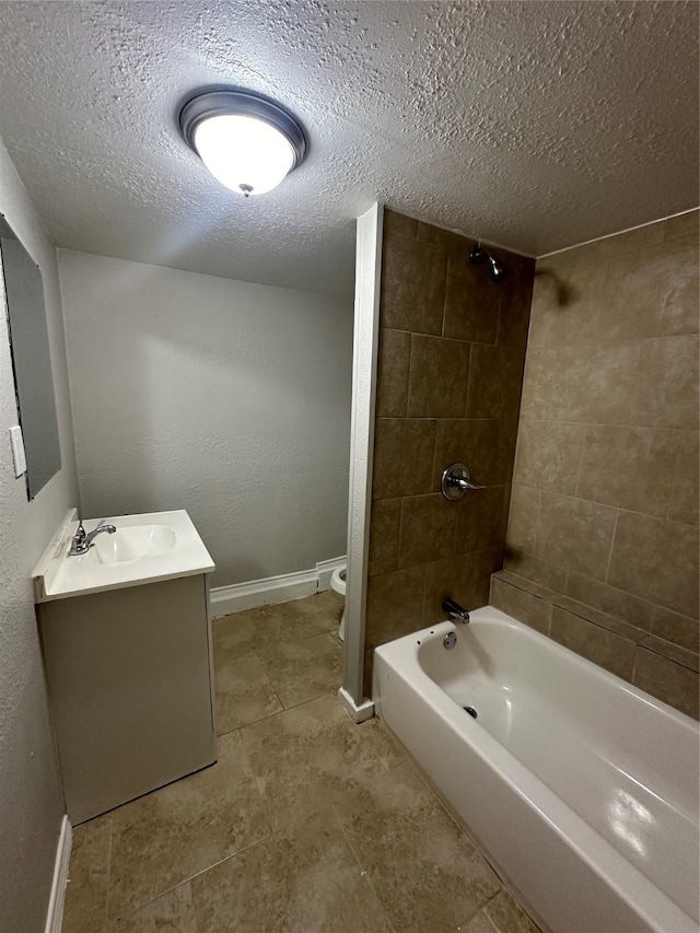 bathroom featuring shower / bath combination, baseboards, toilet, a textured ceiling, and vanity