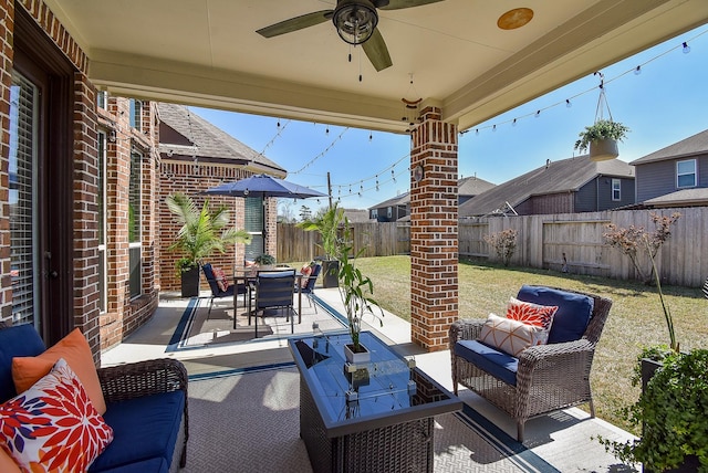 view of patio featuring outdoor lounge area, outdoor dining area, a fenced backyard, and ceiling fan