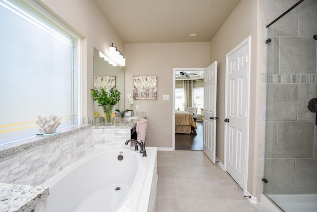 ensuite bathroom with a garden tub, vanity, tile patterned floors, a stall shower, and ensuite bath